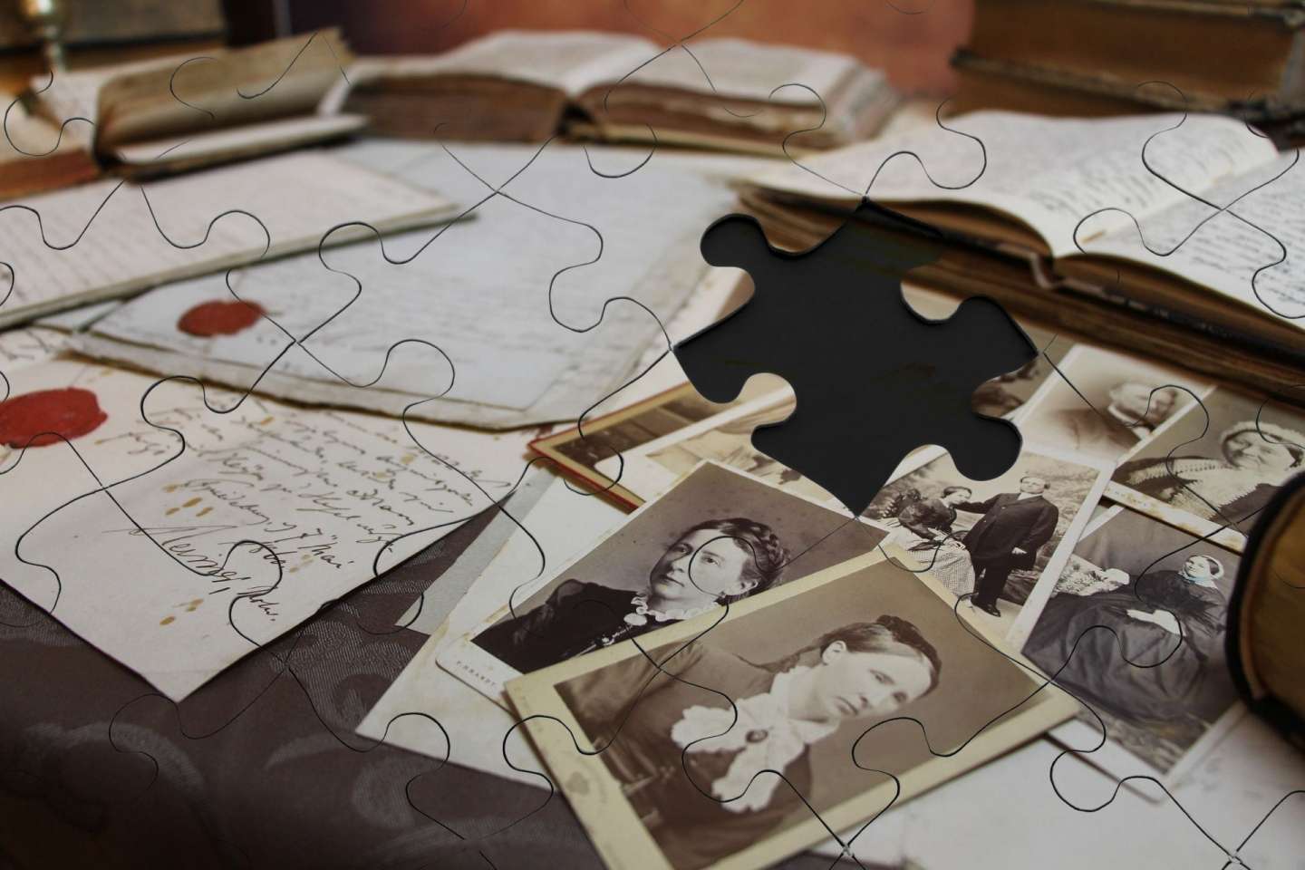 jigsaw puzzle design of table covered by old handwritten letters with red wax seals, open books, and rows of vintage photographs of ladies and couples