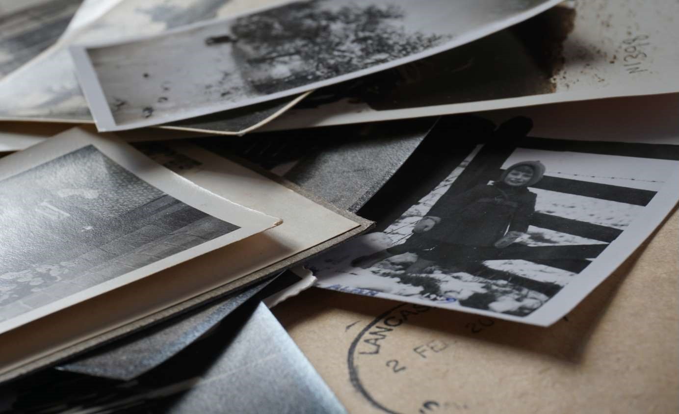 old black and photos stacked with brown postmarked envelopes